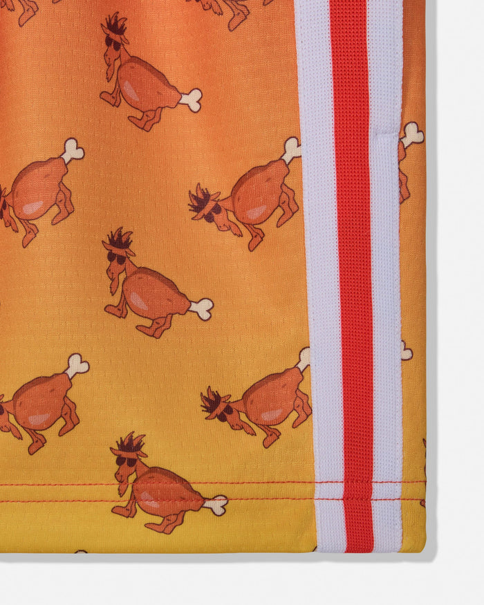 A close-up of a folded textile product, likely a blanket or towel, featuring a repeating cartoon goat print on a yellow-orange background with a vertical red and white striped border.