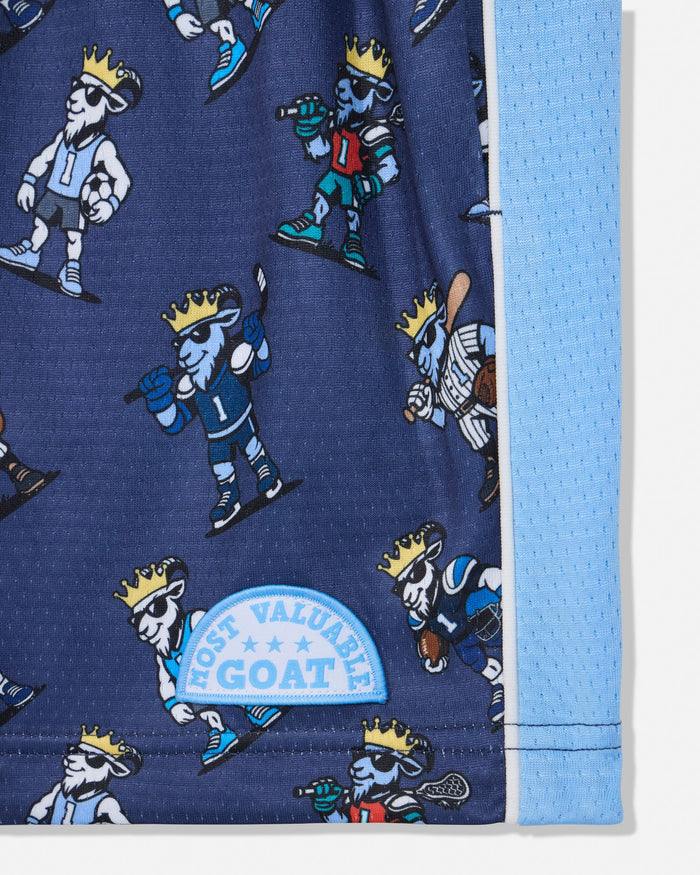 Close-up of a blue athletic fabric product with an allover cartoon goat player print and a light blue mesh side panel. A sewn patch reads 'MOST VALUABLE GOAT'.