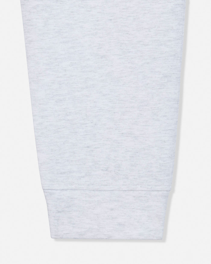Close-up of a light heather gray fabric sleeve or cuff with a ribbed hem, shown against a plain white background.#color_pale-gray