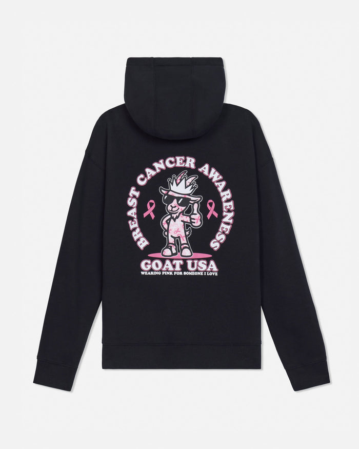 A black hooded sweatshirt shown from the back, featuring a large pink and white graphic print with a cartoon goat character, breast cancer awareness ribbons, and the text 'GOAT USA'.