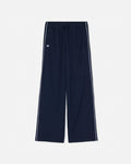 Navy blue wide-leg track pants with white side stripes and a small white embroidered logo on the left thigh, shown against a light gray background.#color_navy-blazer