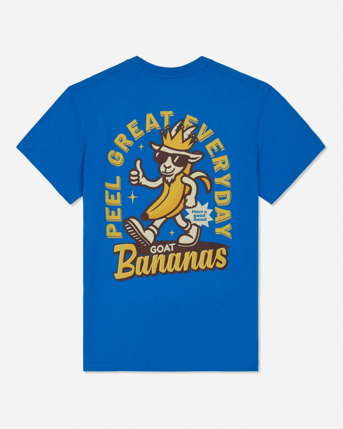 A bright blue short-sleeve t-shirt with a large graphic on the front. The graphic features a cartoon goat wearing sunglasses and a crown, giving a thumbs-up, with the text 'PEEL GREAT EVERYDAY GOAT Bananas' in yellow and brown.