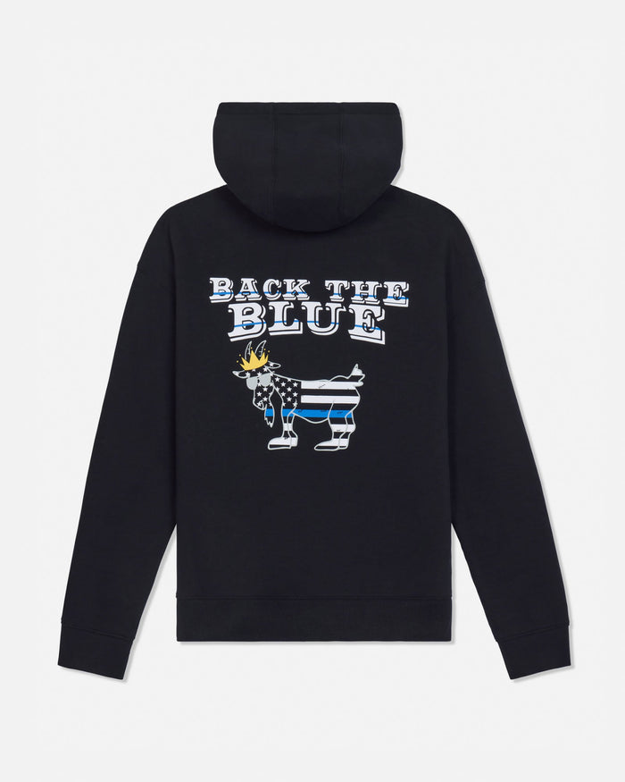A black pullover hoodie shown from the back, featuring a graphic design with the text 'BACK THE BLUE' above a goat filled with a black-and-white American flag pattern and a blue stripe.