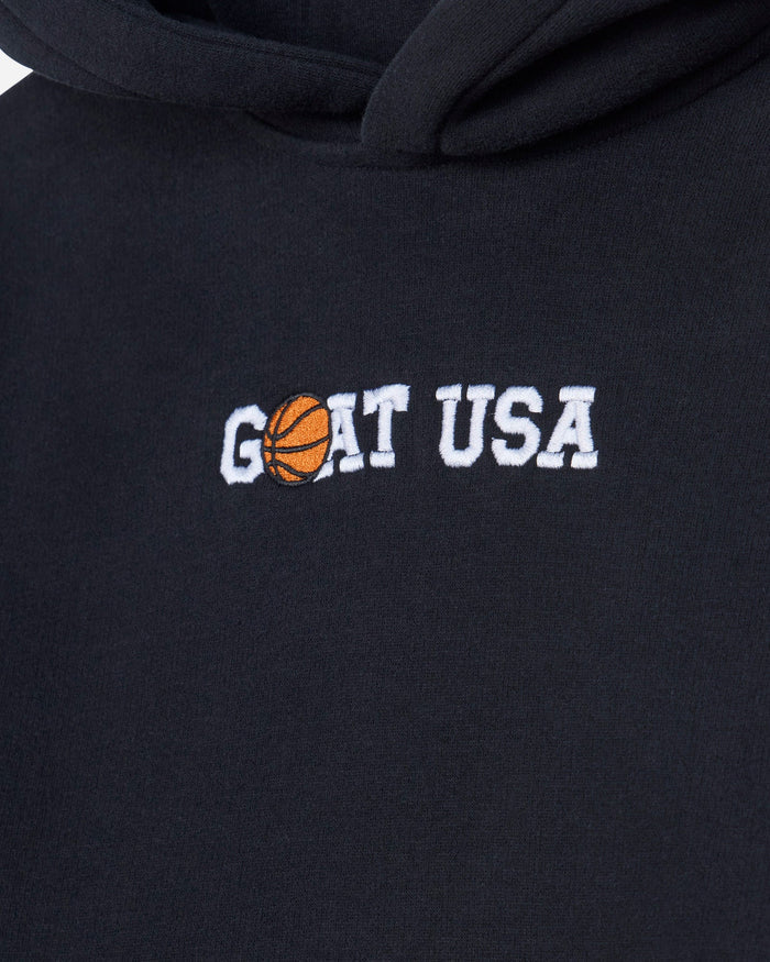 Close-up of a black hoodie featuring an embroidered 'GOAT USA' design on the chest, where the letter 'O' is replaced by an orange basketball graphic.