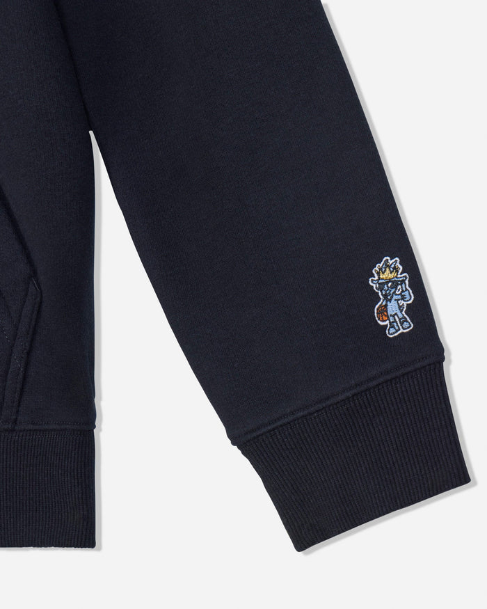 Close-up of a black sweatshirt sleeve with a ribbed cuff and a small embroidered cartoon character on the upper cuff, shown against a light gray background.