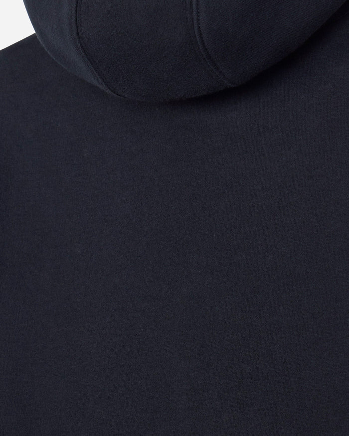 Close-up of a black hooded sweatshirt showing the fabric texture and hood seam.