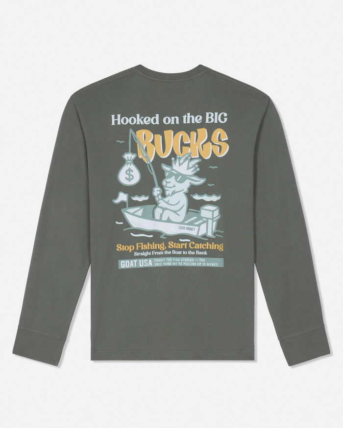 A dark gray long-sleeve t-shirt shown from the back, featuring a graphic print of a cartoon fisherman in a boat with the text 'Hooked on the BIG Bucks' and 'Stop Fishing, Start Catching' in yellow, white, and light blue.