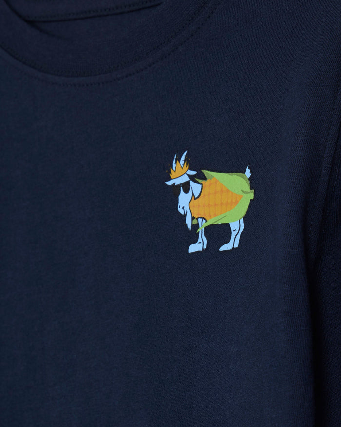 Close-up of a navy blue crewneck sweatshirt featuring a small embroidered cartoon goat wearing a crown on the left chest.