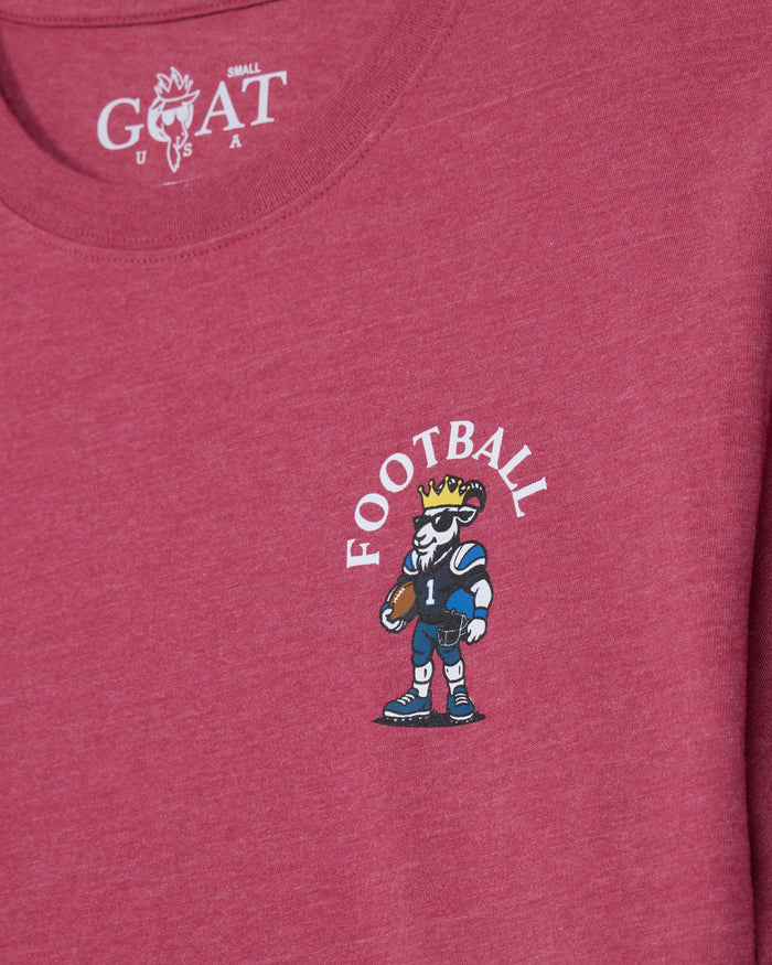 A close-up of a heathered pink t-shirt featuring a cartoon graphic of a football player with a crown and the word 'FOOTBALL' printed on the chest, with the GOAT USA logo visible inside the collar.