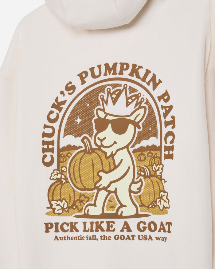 Close-up of a cream-colored hoodie featuring a brown graphic print of a cartoon goat wearing a crown and sunglasses, holding a pumpkin, with the text 'CHUCK'S PUMPKIN PATCH' and 'PICK LIKE A GOAT'.