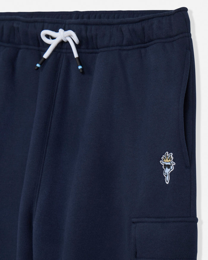 Close-up of navy blue sweatpants with a white drawstring and a small embroidered logo on the left leg.#color_navy-blazer