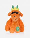 An orange plush goat toy with green horns wearing a yellow crown and black sunglasses, photographed against a clean white background.