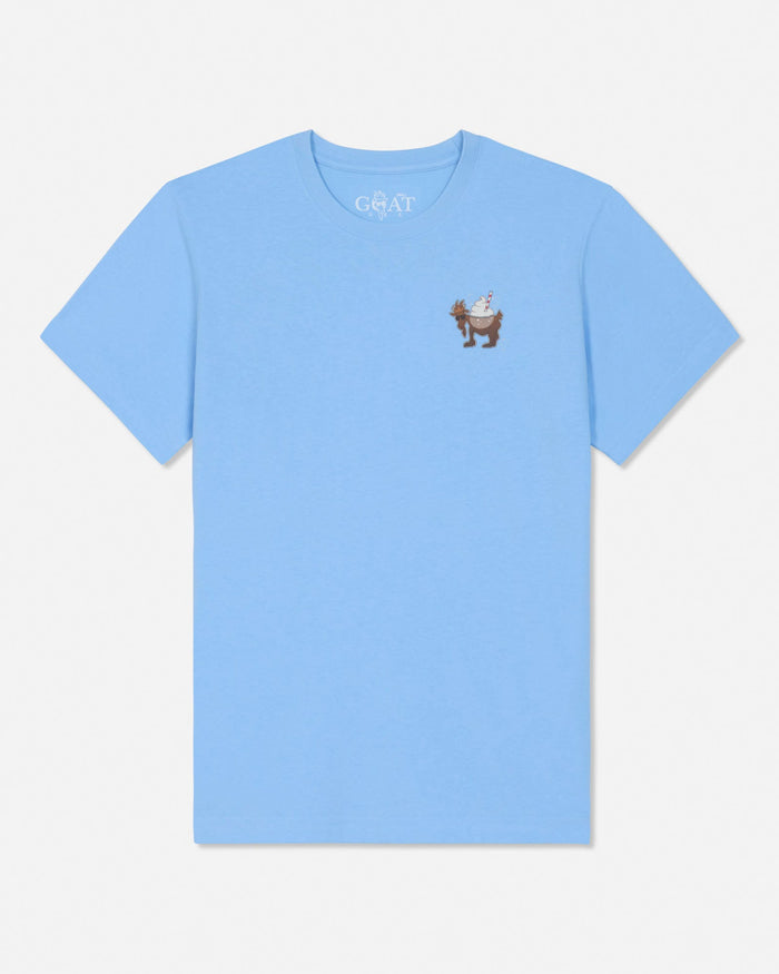 A light blue short-sleeve crewneck t-shirt with a small graphic of a brown goat on the left chest, displayed on a clean white background.