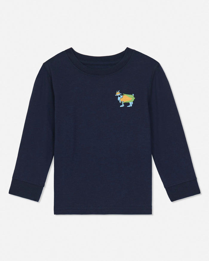 A navy blue long-sleeve crewneck shirt for toddlers, featuring a small colorful goat graphic on the left chest, displayed against a clean white background.